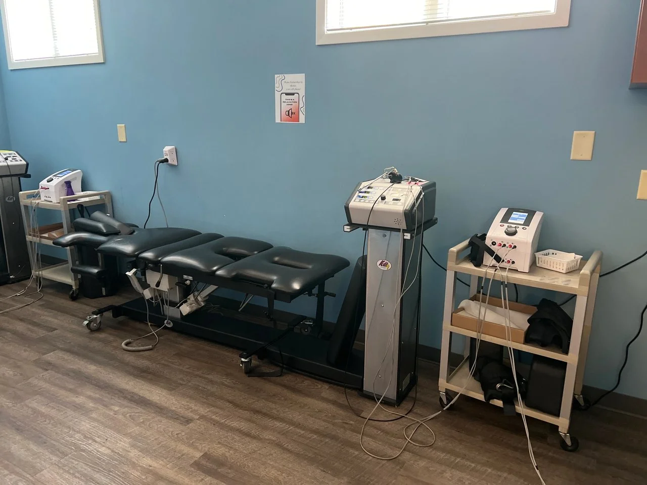 Treatment room with a spinal decompression table and modern therapy equipment
