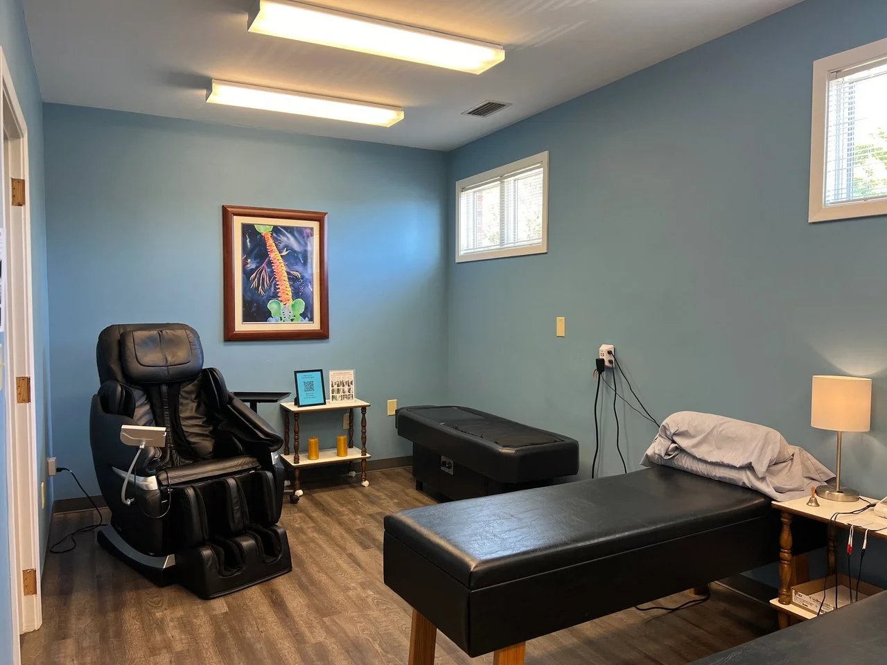 Relaxing therapy room with a massage chair and therapy tables at ProWellness