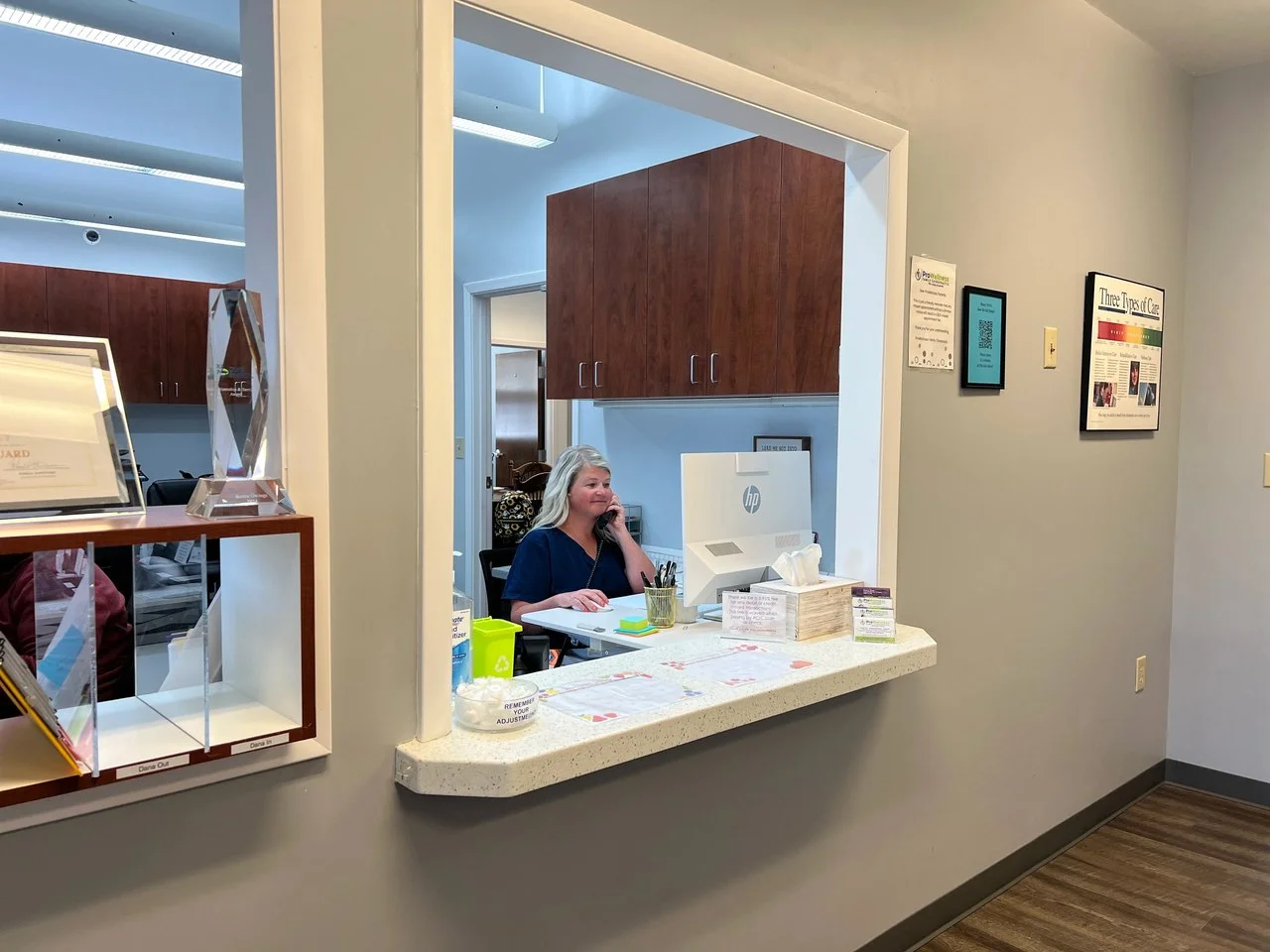 ProWellness Family Chiropractic reception window with a staff member ready to greet patients