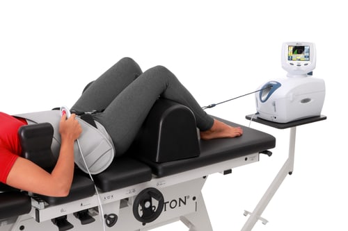 A patient receiving spinal decompression therapy on the traction table