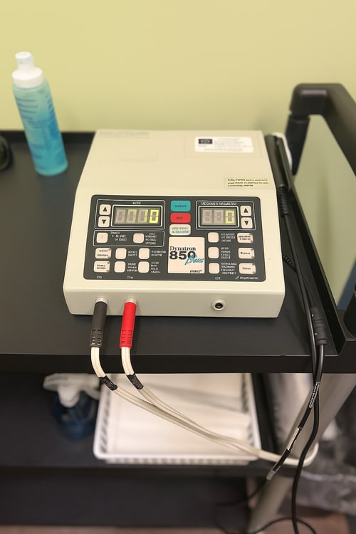 Therapeutic ultrasound unit with handpiece and conductive gel ready for treatment